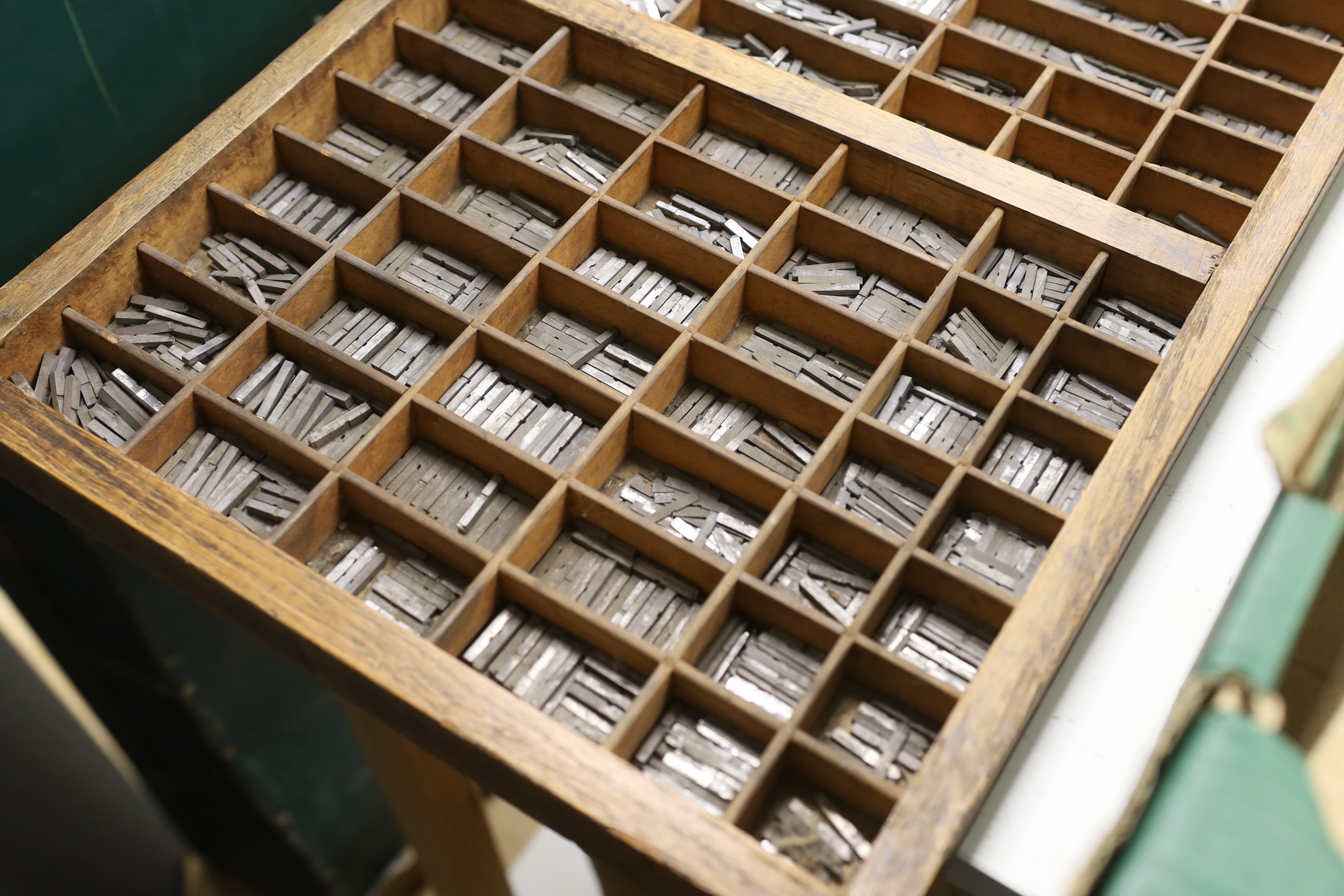 A wooden drawer with dividers as a printer's tray of type set, originally from The Argus building, Brighton, 82 x 36cm